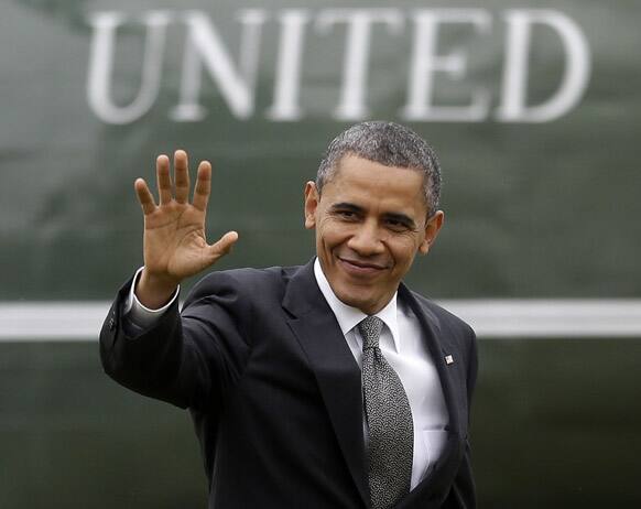 President Barack Obama waves as he walks across the South Lawn of the White House in Washington, upon his arrival on Marine One helicopter, after a quick trip to a Linamar Corporation plant in Arden, N.C., the manufacturer of auto components.