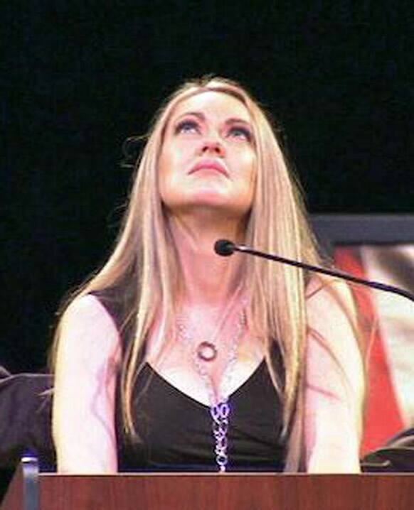 In this image provided by the riverside Police department, Regina Crain, wife of slain Riverside police officer Michael Crain, speaks at his funeral service at Grove Community Church in Riverside, Calif.