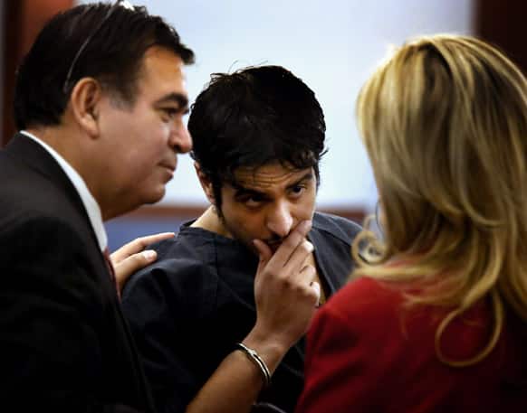 Mazen Alotaib confers with his attorney Don Chairez, left, and court interpreter Theresa Tordjman during his arraignment in District Court. Alotaib, a Royal Saudi Air Force sergeant, pleaded not guilty in the rape of a 13-year-old boy.