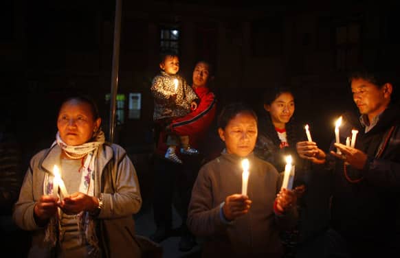 Exile Tibetans participate in a candle light vigil in solidarity with fellow Tibetans who have self immolated, in Katmandu, Nepal.