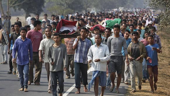 Members of the Rabha tribe carry bodies of the victims of Tuesday’s clashes resulting from protests against a local government election in Darrangiri Kasadol village, about 135 kilometers (84 miles) west of Gauhati, capital of the northeastern Indian state of Assam.