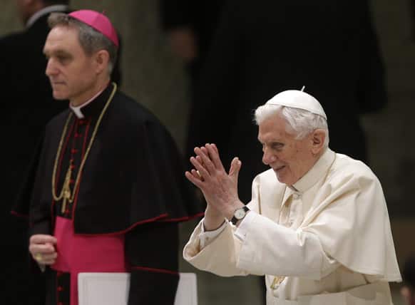 Pope Benedict XVI is flanked by his private secretary Archbishop Georg Ganswein as he arrives for his weekly general audience at the Paul VI Hall at the Vatican.