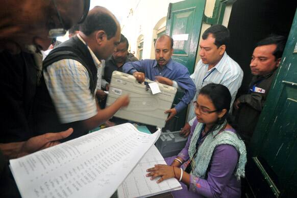 Election officials receive electronic voting machines before moving to their respective polling stations ahead of the Tripura state elections in Agartala.