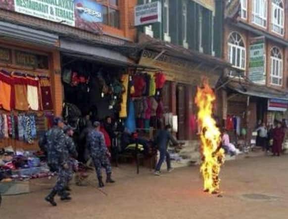 Nepalese policemen rush as a Tibetan monk burns after he set himself on fire in Katmandu. The Tibetan monk doused himself with gasoline and set himself on fire in Nepal`s capital Wednesday in what is believed to be the latest self-immolation to protest Chinese rule in Tibet.