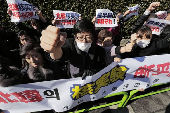 South Korean residents in Japan protest hold a banner and raise clinched fists as they stage a protest rally against North Korea`s nuclear test outside the General Association of Korean Residents in Tokyo.