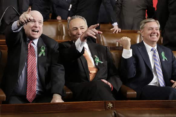 From left, Sen. John McCain, R-Ariz., Sen. Charles Schumer, D-N.Y. and Sen. Lindsey Graham, R-S.C. sit on Capitol Hill in Washington, before President Barack Obama`s State of the Union address during a joint session of Congress.