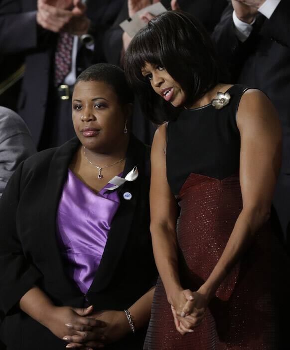 First lady Michelle Obama stands with Cleopatra Cowley-Pendelton before President Barack Obama`s State of the Union address during a joint session of Congress on Capitol Hill in Washington.