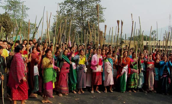 Members of the Rabha tribe stand with sticks and brooms block a road protesting a local government election in Goalpara district, 120 kilometers (75 miles) from Gauhati.