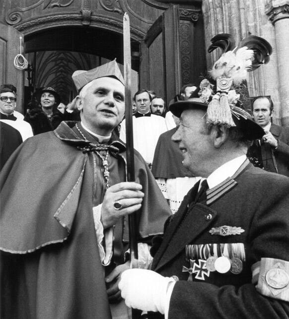 FILE - The Feb. 28, 1982 file photo shows then Cardinal Joseph Ratzinger, left, testing the sharpness of the sabre of mountaineer Andreas Stadler, right, in Munich. Joseph Ratzinger, who later became Pope Benedict XVI, announced Monday, Feb. 11, 2013 that he will resign on Feb. 28.