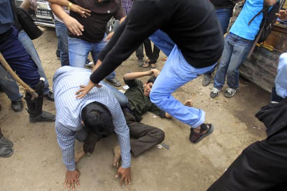 Bangladeshi government supporters beat a Jamaat-e-Islami activist on a street during a demonstration by the country’s largest Islamic party against the conviction of their leader, in Dhaka.