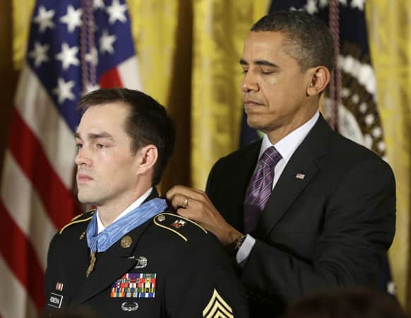 President Barack Obama bestows the Medal of Honor on retired Staff Sgt. Clinton Romesha for conspicuous gallantry,in the East Room of the White House.
