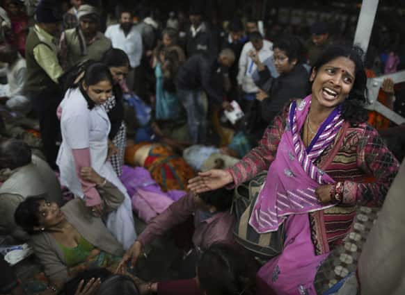 An Indian woman weeps as she and other family members mourn next to the body of a relative who was killed in a stampede on a railway platform at the main railway station in Allahabad.