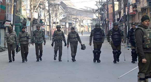 Policemen patrol a street on the second consecutive day of curfew imposed after the execution of a Kashmiri man convicted in a deadly 2001 attack on India`s Parliament in Srinagar.