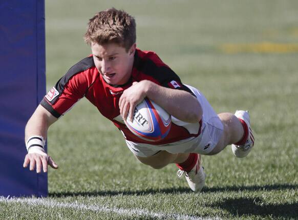Lucas Hammond dives across the goal line to score a try against Uruguay during a Sevens Rugby World Series match, in Las Vegas. Canada won 36-0.