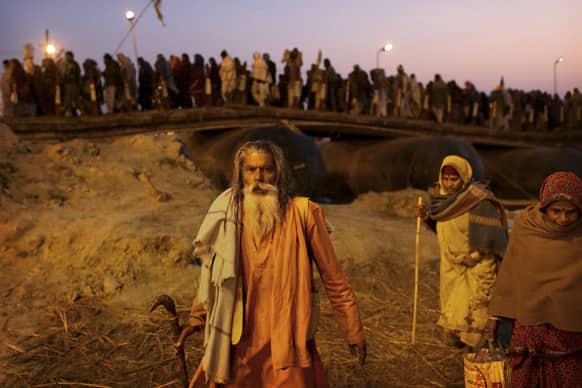 Hindu holy man arrives with devotees at Sangam, the confluence of the Rivers Ganges, Yamuna and mythical Saraswati, during Maha Kumbh festival, in Allahabad.