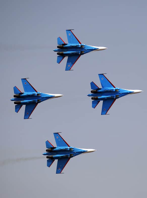 Russian air force air demonstration team`s Sukhoi Su-27 fighters of Russian Knights perform on the fourth day of the Aero India 2013 at Yelahanka air base in Bangalore.