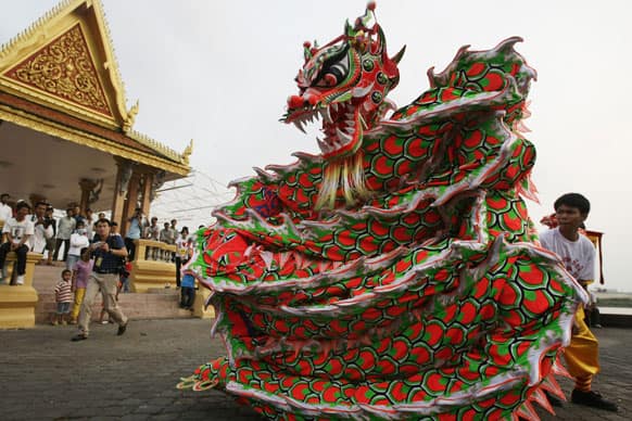 Ethnic Cambodian Chinese people perform a dragon dance in front of the Royal Palace ahead of Lunar New Year, in Phnom Penh, Cambodia.