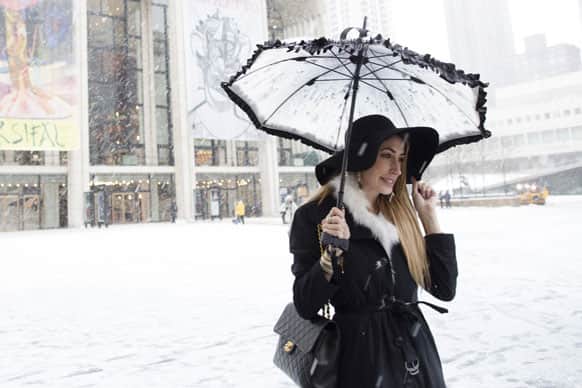 Lauren Rae Levy, of Manhattan, stands outside the Metropolitan Opera House in the snow at Lincoln Center during Fashion Week.