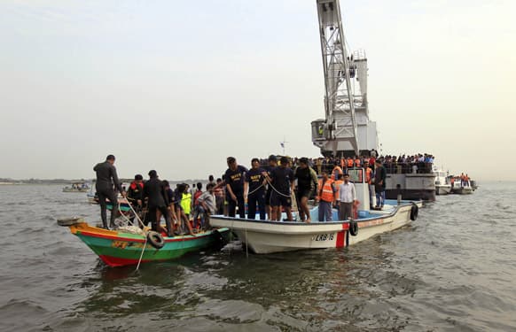 Bangladesh`s navy members search for victims of a ferry accident in the River Meghna at Munshiganj, south of Dhaka. A passenger ferry capsized Friday after colliding with another ship on the river in central Bangladesh, dumping as many as 100 people into the water.