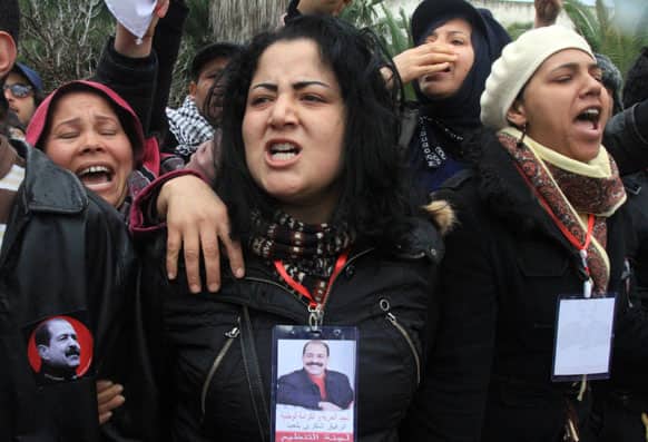 Tunisian women gather in front of the house of slain opposition leader Chokri Belaid`s father prior to his funeral in Tunis.