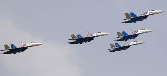 The Russian Knights, the aerobatic team of the Russian Air Force, performs in their Sukhoi Su-27 and Su-27UB fighter aircraft on the third day of the Aero India 2013 at Yelahanka air base in Bangalore.