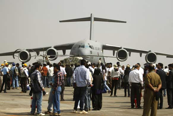 Visitors crowd near a US Air Force C-17 Globemaster, a transport aircraft, on display on the second day of the Aero India 2013 at Yelahanka air base in Bangalore.