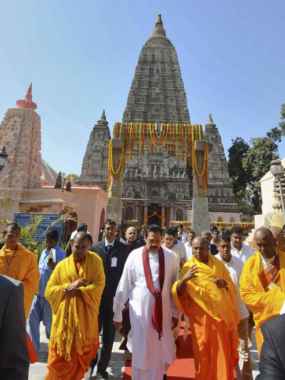 Sri Lankan President Mahinda Rajapaksa leaves after offering prayers during a visit to the Mahabodhi temple in Bodh Gaya.