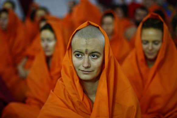 Female foreign devotees participate in a consecration ceremony for becoming Hindu holy women at Pilot Baba camp at Sangam, the confluence of rivers Ganges, Yamuna and mythical Saraswati, as part of the Maha Kumbh festival in Allahabad,