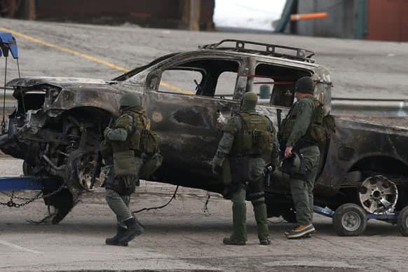 A burned-out pickup truck belonging to ex-Los Angeles police officer Christopher Dorner is towed after it was discovered in Big Bear, Calif.