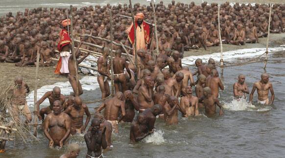 Hindu holy men of the Juna Akhara sect take a dip in the river Ganges during a rituals that are believed to rid them of all ties in this life and dedicate themselves to serving God as a