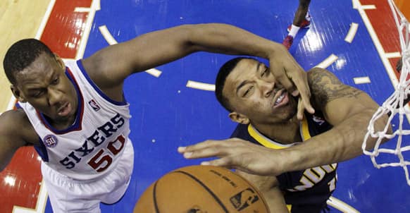 Indiana Pacers` Orlando Johnson, right, is fouled by Philadelphia 76ers` Lavoy Allen while taking a shot during the second half of an NBA basketball game, in Philadelphia.
