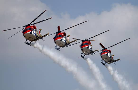 Indian Air Force helicopters perform aerobatic flight on the opening of the Aero India 2013 at Yelahanka air base in Bangalore.