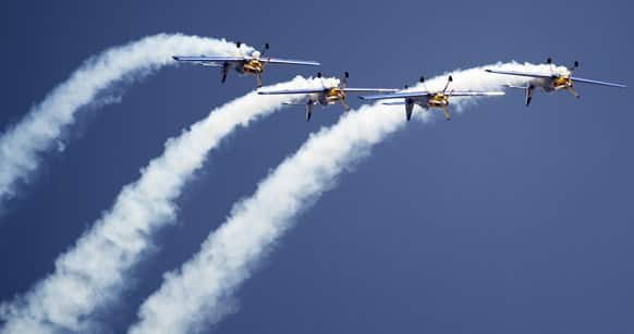 Flying Bulls Zlin 50LX single-engine and single-seater aerobatic display team from the Czech Republic perform on the opening of the Aero India 2013 at Yelahanka air base in Bangalore.