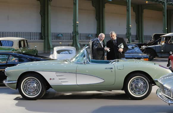 Visitors look at a Chevrolet Corvette Roadster 1960 at the Grand Palais in Paris. The car is expected to fetch between euro 75,000 to 95,000 ($101,50-128,570) at Thursday`s auction sale.