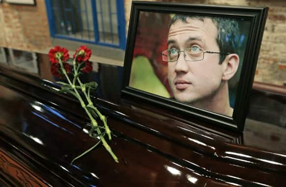 A portrait of Alexander Dolmatov is on display during mourning ceremony in Moscow. Relatives held funeral services Monday for Alexander Dolmatov, 36, who Dutch authorities say killed himself in a Rotterdam asylum deportation center last month.