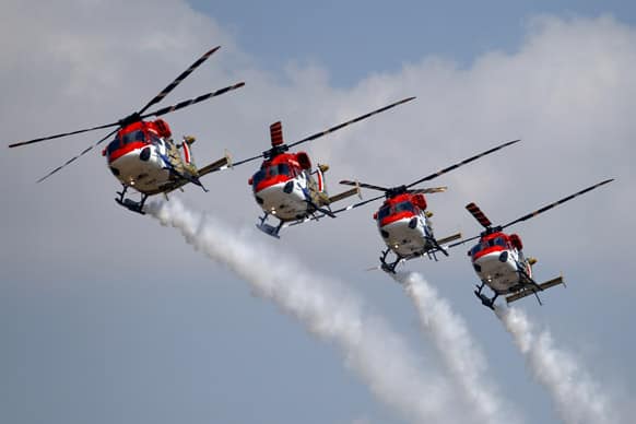 Indian Air Force helicopters perform aerobatic flight on the opening of the Aero India 2013 at Yelahanka air base in Bangalore.