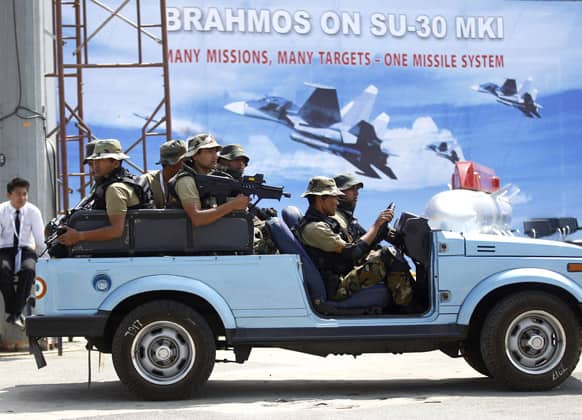 Indian military commandoes patrol during rehearsals on the eve of the Aero India 2013 at Yelahanka air base in Bangalore.