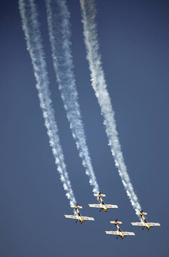 Red Bull `s Zlin 50LX single-engine and single-seater aircrafts perform during rehearsals on the eve of the Aero India 2013 at Yelahanka air base in Bangalore.