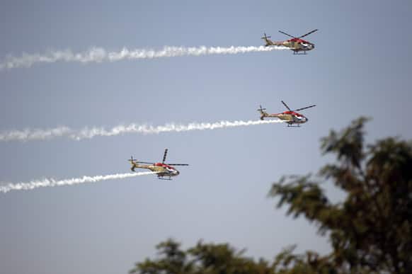 Indian Air Force helicopters perform aerobatic flight during rehearsals ahead of the Aero India 2013 in Yelahanka air base in Bangalore.