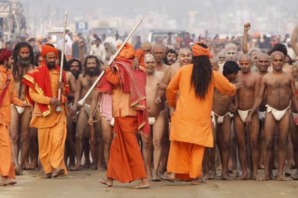 Hindu holy men of the Juna Akhara sect get ready for a rituals that are believed to rid them of all ties in this life and dedicate themselves to serving God as a `Naga` or naked holy men, at Sangam during the Maha Kumbh festival in Allahabad.