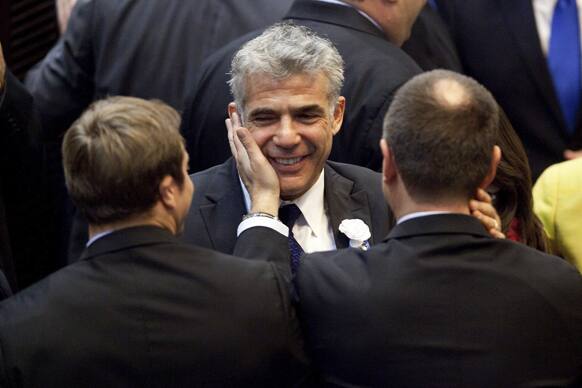 Yair Lapid, leader of the Yesh Atid (There is a Future) party, center, during the opening session of Israel`s newly elected parliament in Jerusalem.