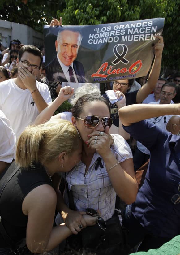 Supporters of the late Paraguayan presidential candidate Lino Oviedo react as his coffin is taken to another location for his wake in Asuncion, Paraguay.