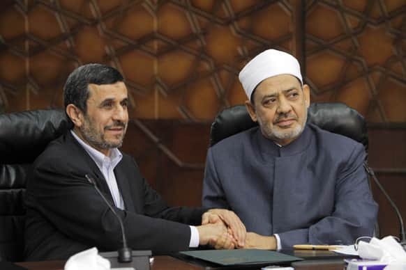 Iran`s President Mahmoud Ahmadinejad, left, shakes hands with Grand Sheik Ahmed al-Tayeb, the head of Al-Azhar, the Sunni Muslim world`s premier Islamic institution during their meeting at Al Azhar headquarters in Cairo.