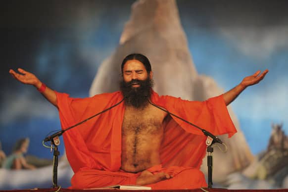 Baba Ramdev performs yoga at Sangam, the confluence of rivers Ganges, Yamuna and mythical Saraswati during the Maha Kumbh festival in Allahabad.
