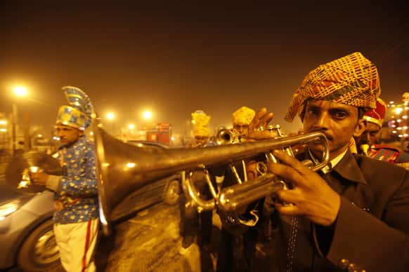 A brass band participates in a religious procession towards the Sangam, the confluence of rivers Ganges, Yamuna and mythical Saraswati, as part of the Maha Kumbh festival in Allahabad.