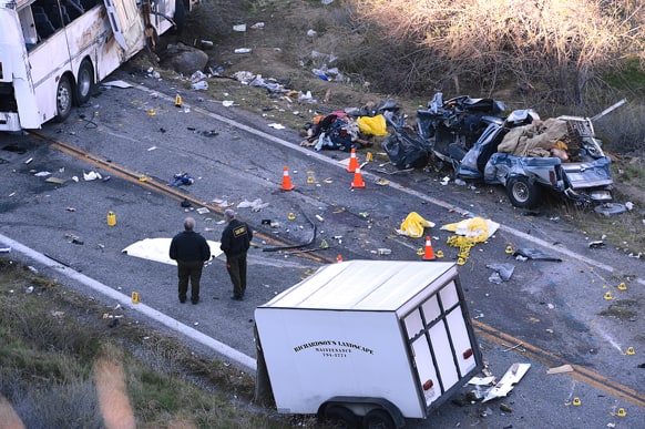 Authorities work at the scene of Sunday`s fatal tour bus crash on Highway 38 north of Yucaipa, Calif., that left at least eight people dead and dozens injured. The cause of the Sunday crash east of Los Angeles remained under investigation.