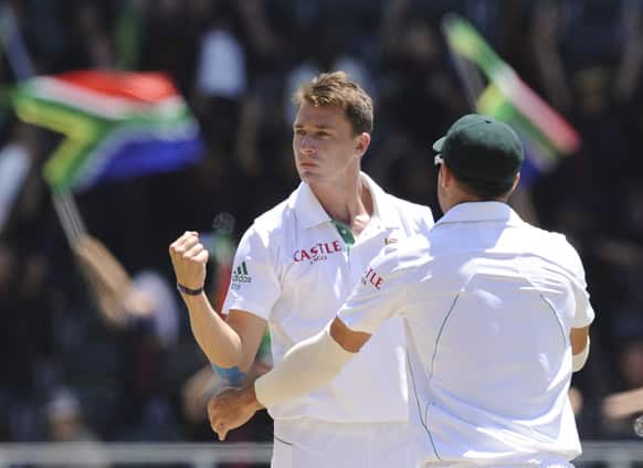 South Africa`s Dale Steyn, left, celebrate with Dean Elgar after taking the wicket of Misbah-ul-Haq of Pakistan for 64 runs during their cricket test match in Johannesburg.