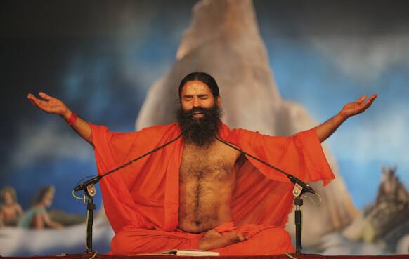 Yoga guru Baba Ramdev performs yoga at Sangam, the confluence of rivers Ganges, Yamuna and mythical Saraswati during the Maha Kumbh festival in Allahabad.
