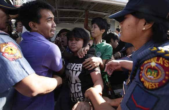 Police arrest protesters as they attempt to stage a rally at the gates of the Presidential Palace, in Manila, Philippines.