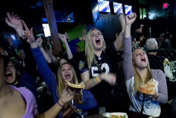 Baltimore Ravens fans celebrates after their team scored the first touchdown against San Francisco 49ers, at local pub in Baltimore.